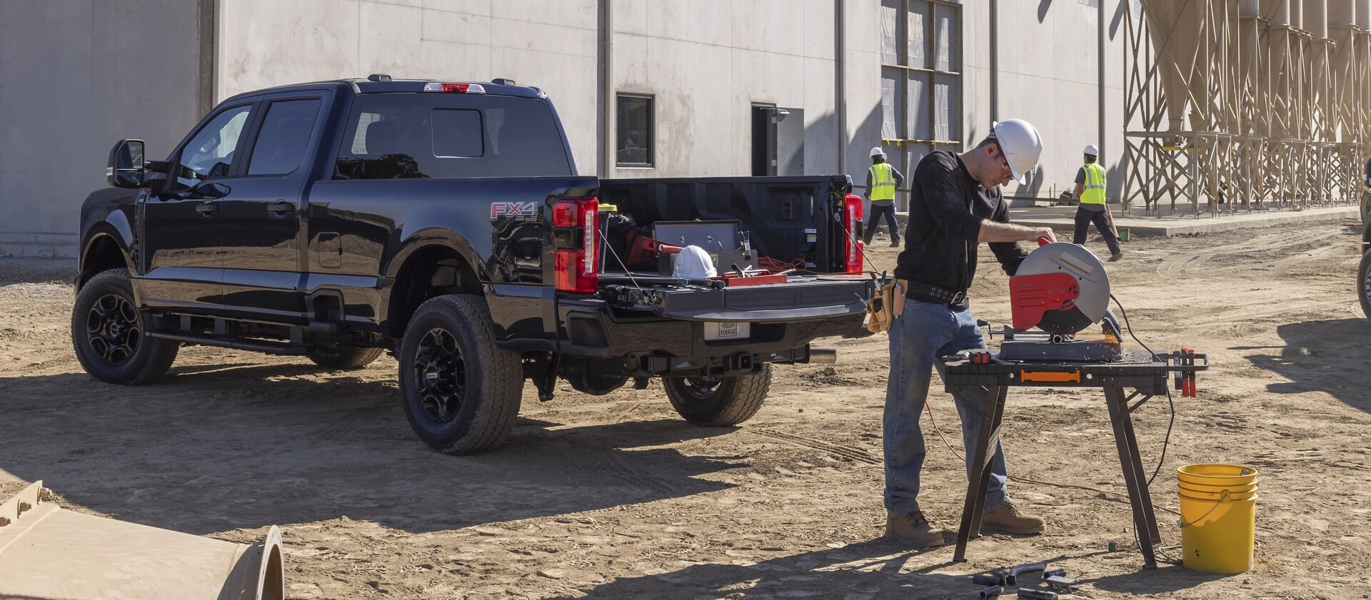 2026 Ford Super Duty® F-250® XL with the STX® Appearance Package parked on a construction site with a person walking near it