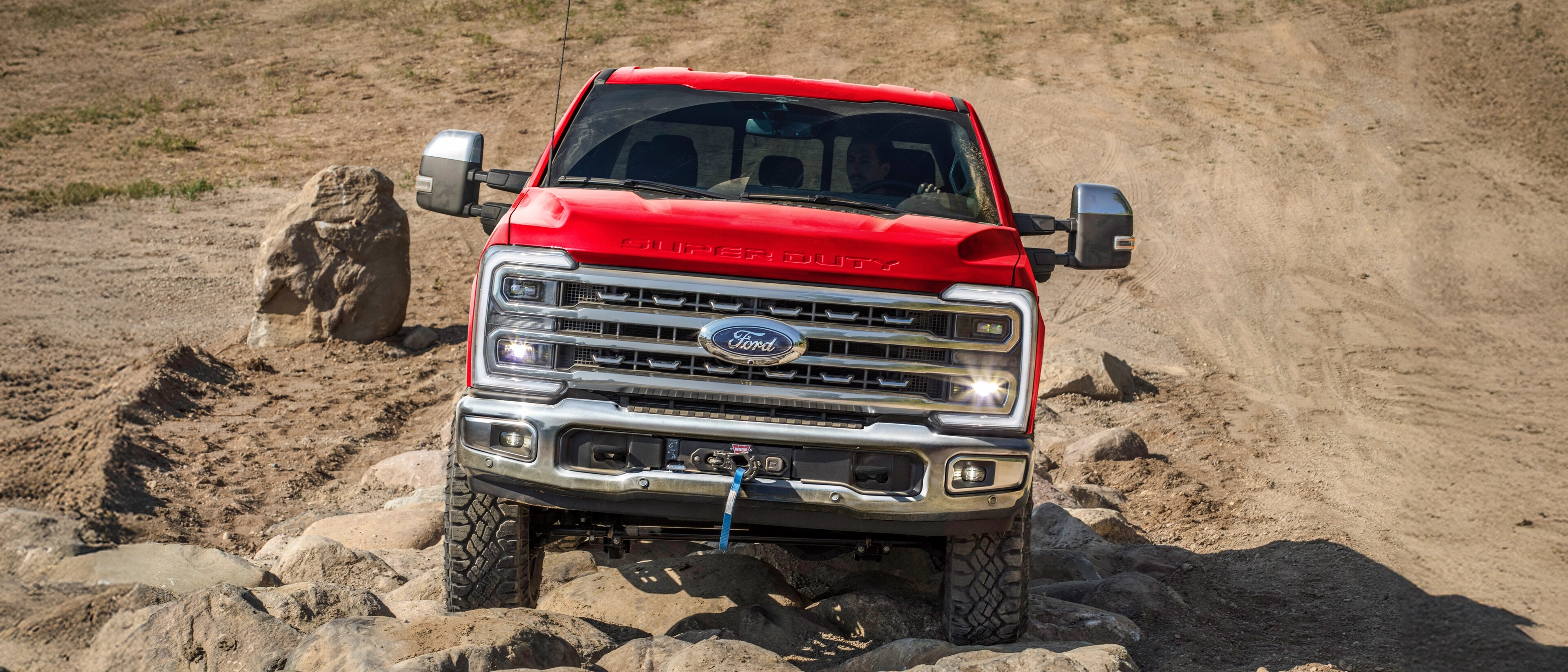 2026 Ford Super Duty® F-250® with the Tremor® Off-Road Package driving on rocky terrain