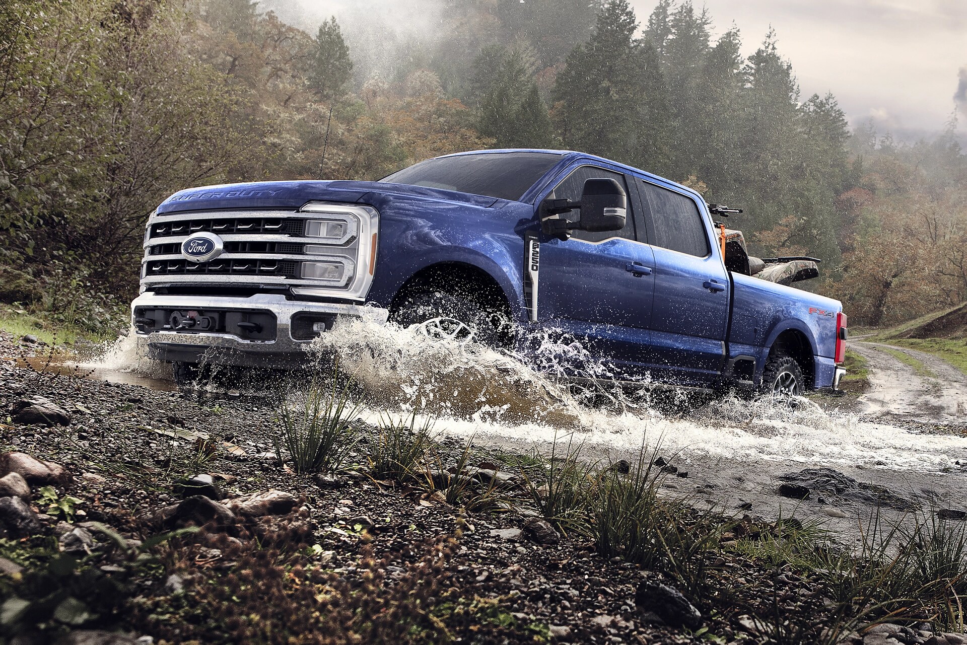 2026 Ford Super Duty® F-350® XL with the Tremor® Off-Road Package driving through a shallow creek