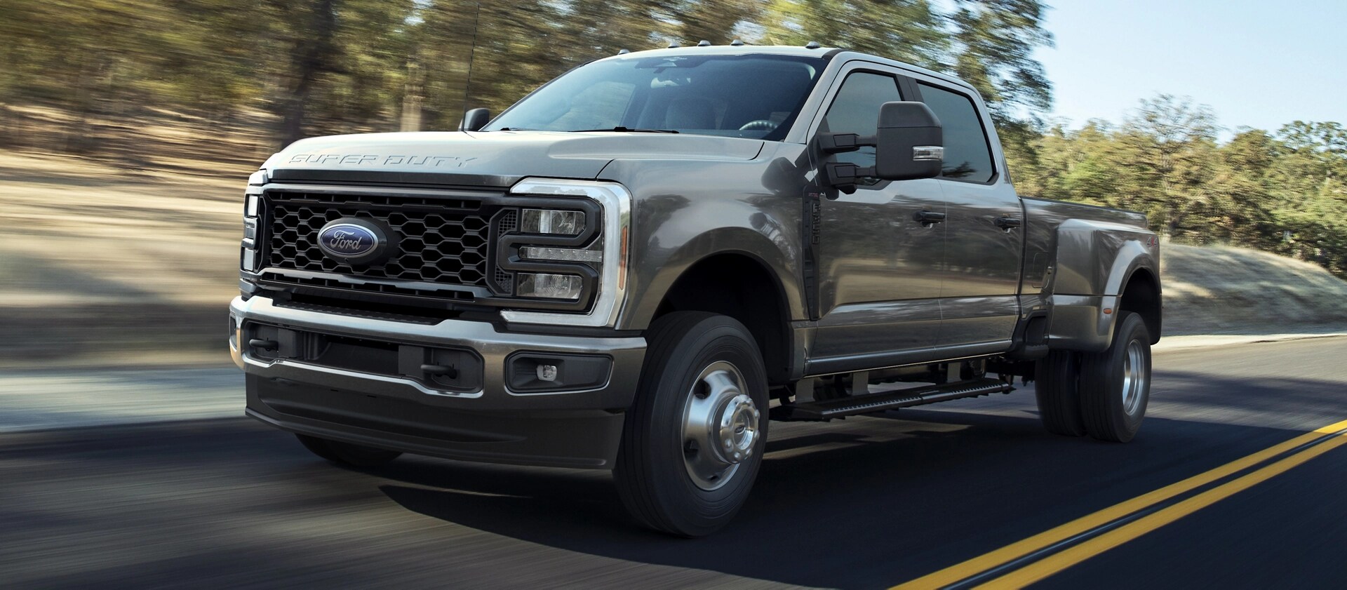 2026 Ford Super Duty® F-250® XL with the STX® Appearance Package in Carbonized Grey driving on a paved road