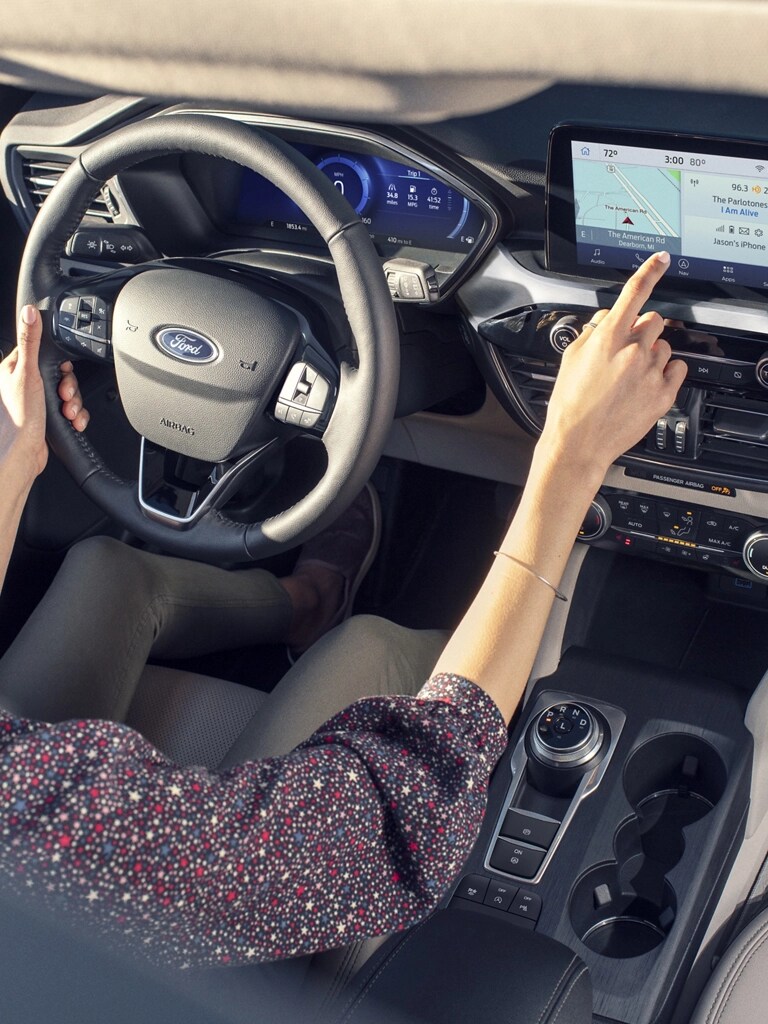 A woman driving a Ford vehicle