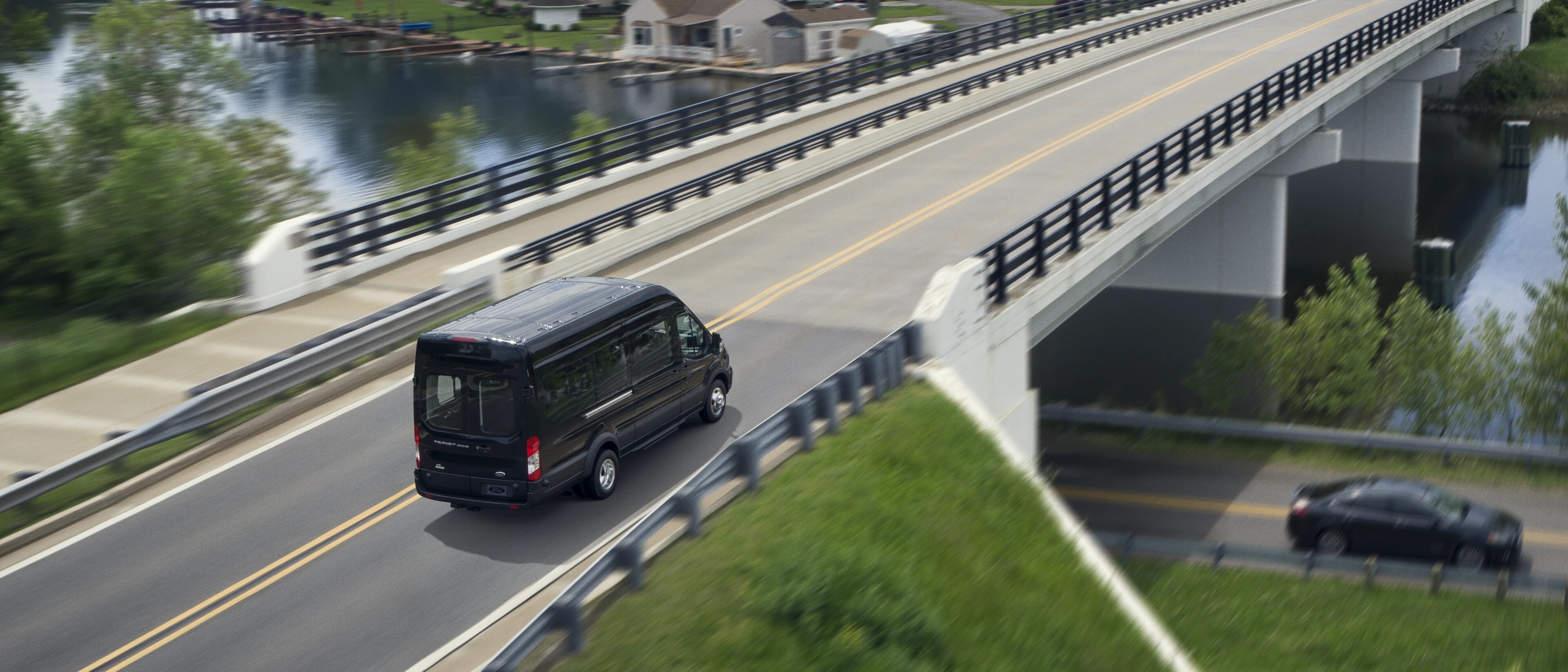Overhead shot of a 2025 Ford Transit® Van being driven over a highway overpass