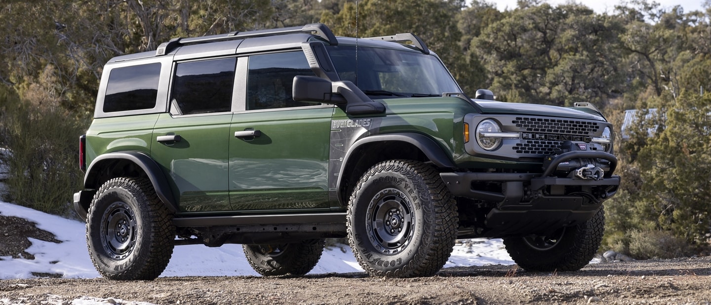 A 2023 Ford Bronco® Everglades™ model in Eruption Green Metallic parked on rough terrain