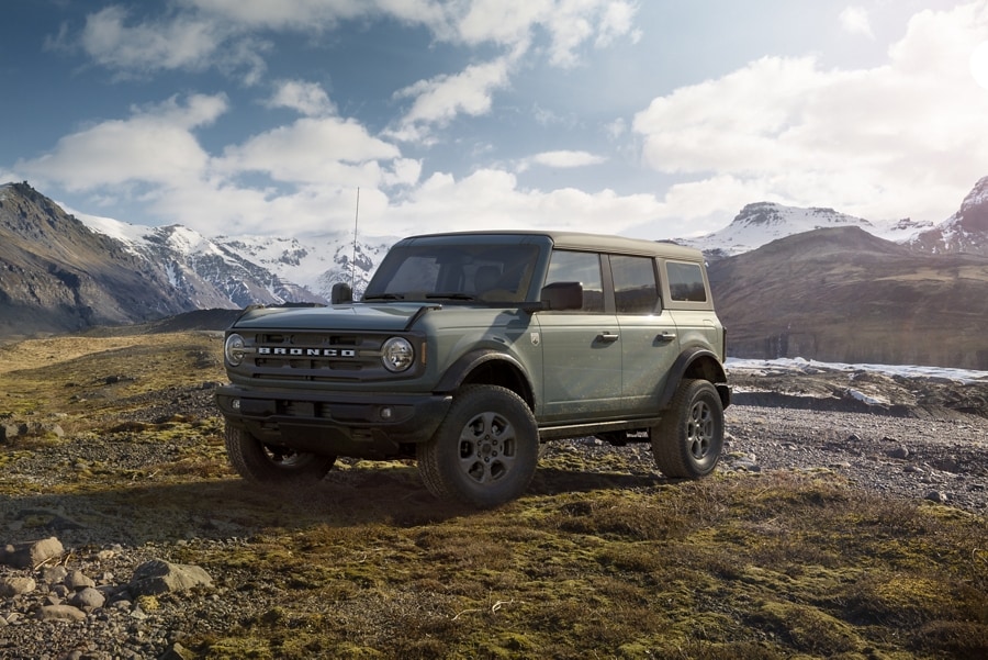 A 2023 Ford Bronco® Big Bend™ model in Cactus Grey parked on a hill with mountains in background