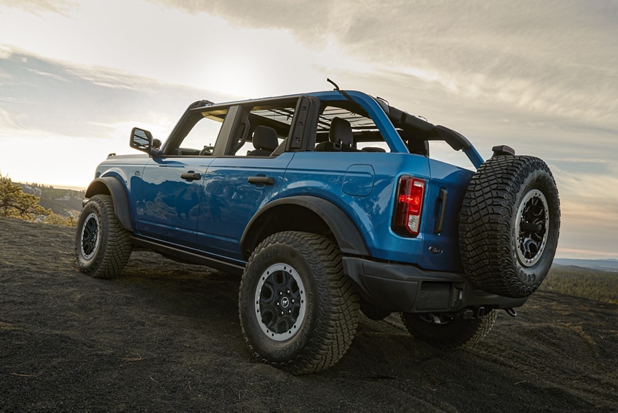 A 2023 Ford Bronco® four-door SUV in Velocity Blue Metallic parked on a scenic overlook