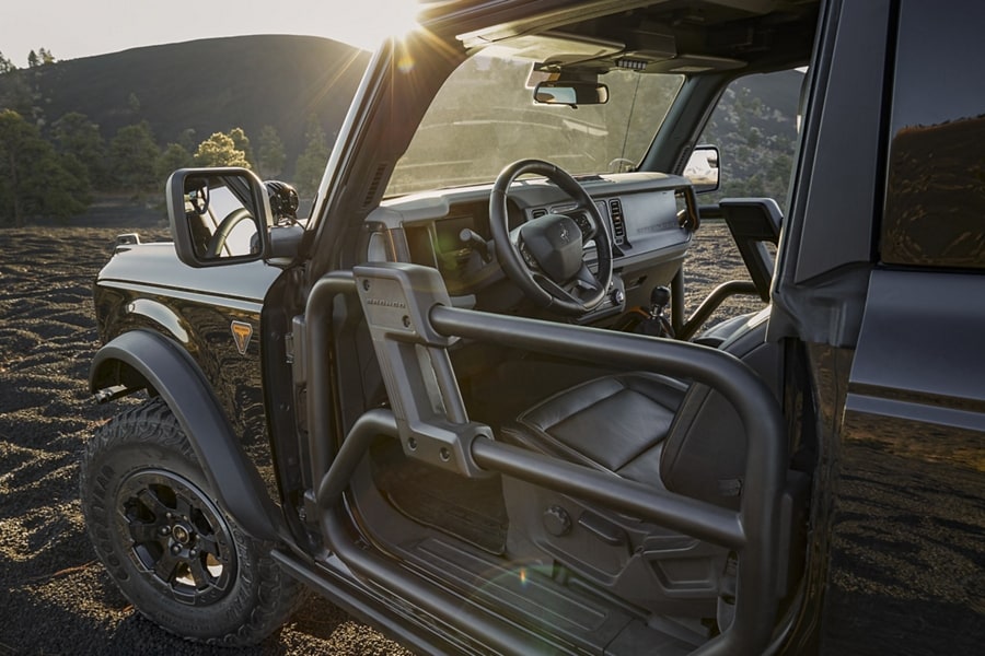 4-door 2023 Ford Bronco® Badlands™ model in Shadow Black with available aftermarket tube doors