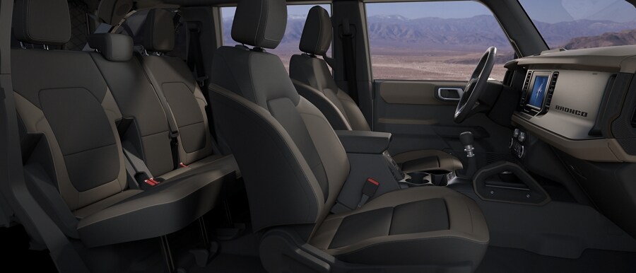 Interior of 2023 Ford Bronco® SUV showing cloth seats in Medium Sandstone with Black Onyx