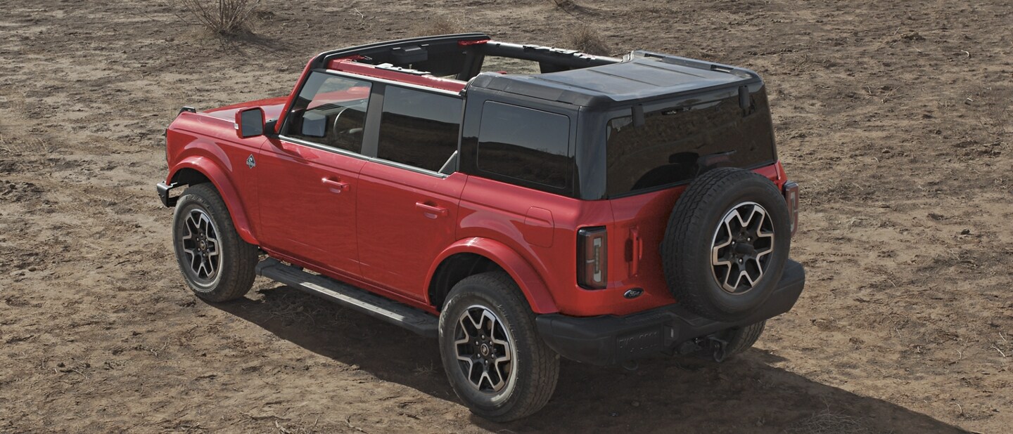 4-door 2023 Ford Bronco® Outer Banks™ model shown in Race Red with hardtop half removed