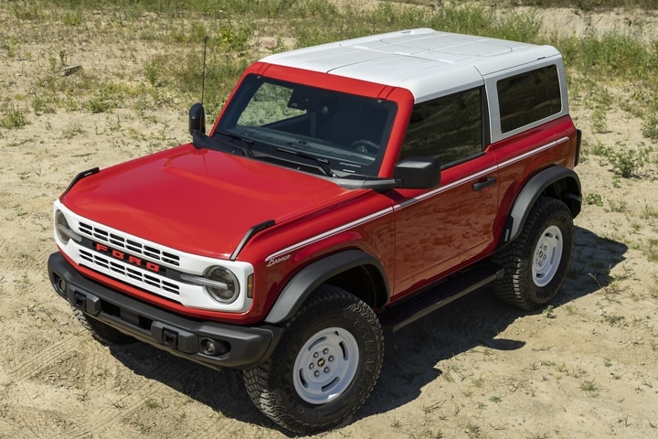 A 2023 Ford Bronco® Heritage model in Race Red parked in dirt path