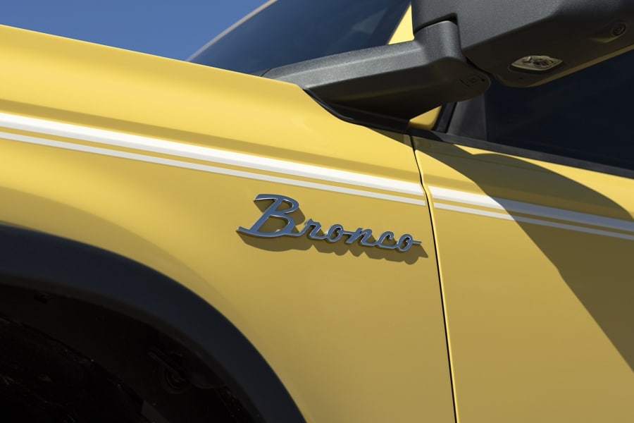Close-up of chrome Bronco® badge on fender of a 2023 Ford Bronco® Heritage Limited model in Yellowstone