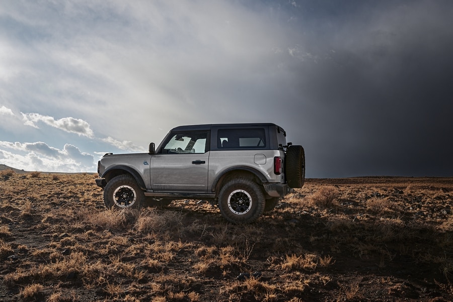2-door 2023 Ford Bronco® Black Diamond™ in Iconic Silver Metallic parked in the wilderness