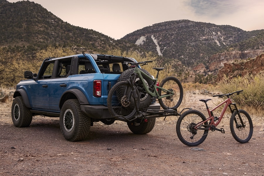 4-door 2024 Ford Bronco® in Velocity Blue Metallic with bikes on a hitch-mounted bike rack