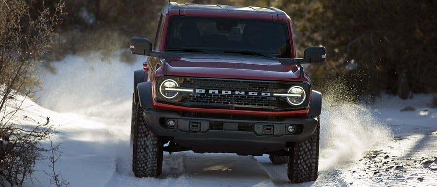 2024 Ford Bronco® WildTrak™ model off-roading on trail covered in snow