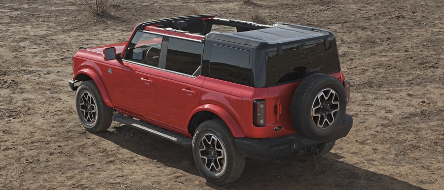 4-door 2024 Ford Bronco® Outer Banks™ model shown in Race Red with hardtop half removed