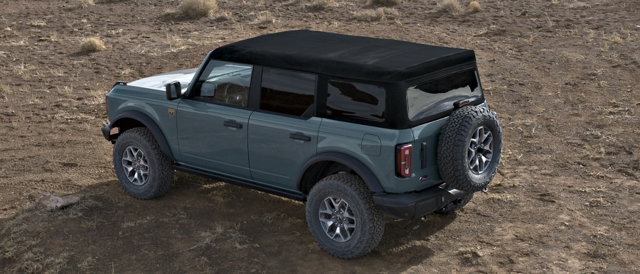 4-door 2024 Ford Bronco® Badlands™ shown in Azure Grey Metallic Tri-Coat with soft top roof