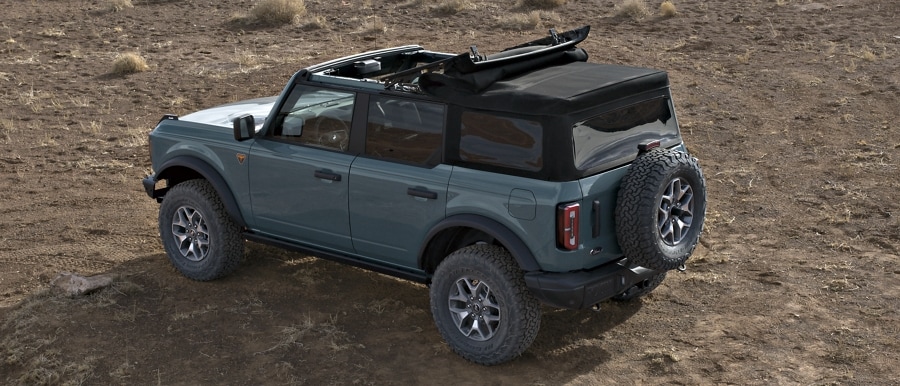 4-door 2024 Ford Bronco® Badlands™ shown in Azure Grey Metallic Tri-Coat with Soft Top roof half open