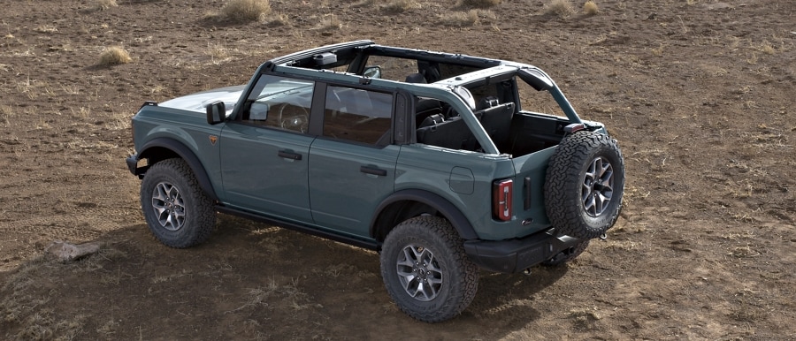 4-door 2024 Ford Bronco® Badlands™ model shown in Azure Grey Metallic Tri-Coat with soft top roof fully removed