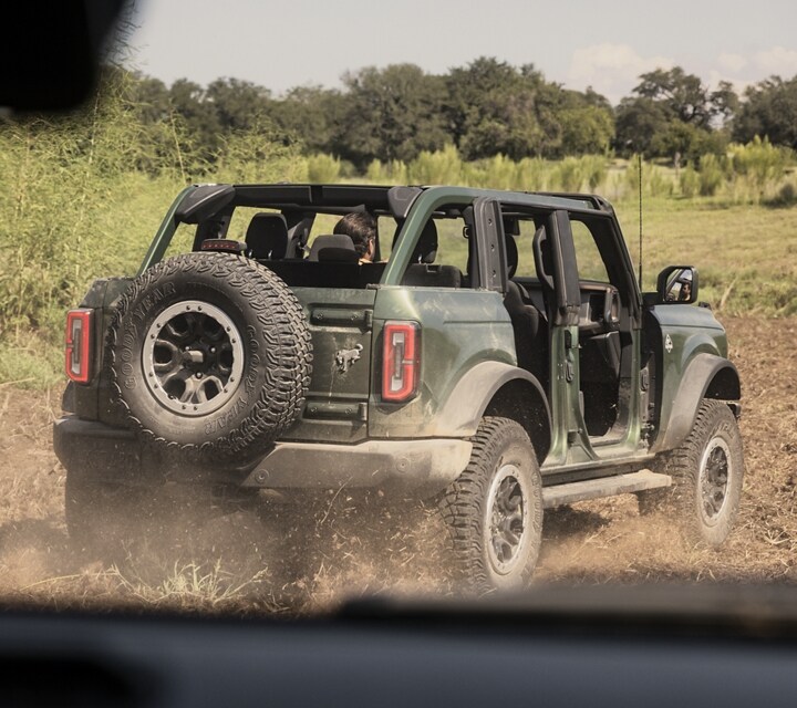 A 2024 Ford Bronco® Outer Banks® with doors removed and top off being driven off-road