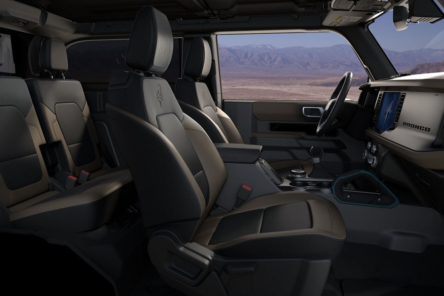 Side view of the interior of a 4-door 2024 Ford Bronco® during the day parked in a desert