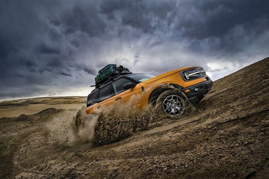 A 2023 Ford Bronco® Sport being driven up a dirt hill