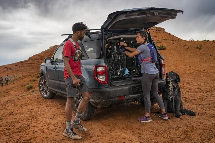 Two people standing outside of their 2023 Ford Bronco® Sport