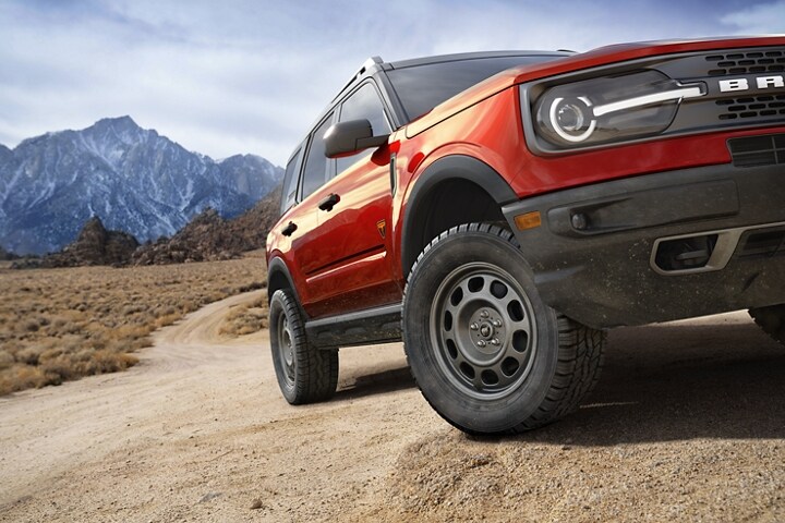 A 2023 Ford Bronco® Sport SUV shown in Hot Pepper Red with the mountains in the background