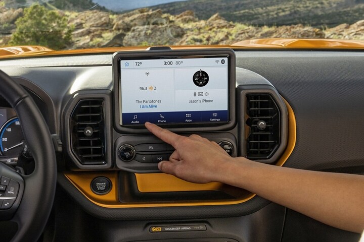 Two people using the 8” touchscreen in a 2023 Ford Bronco® Sport SUV