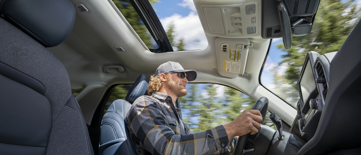 Man driving in a 2023 Ford Bronco® Sport SUV with the moonroof open