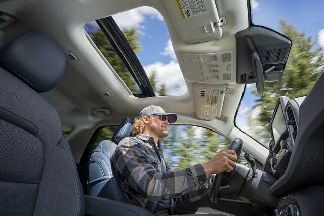 Man driving in a 2023 Ford Bronco® Sport SUV with the moonroof open