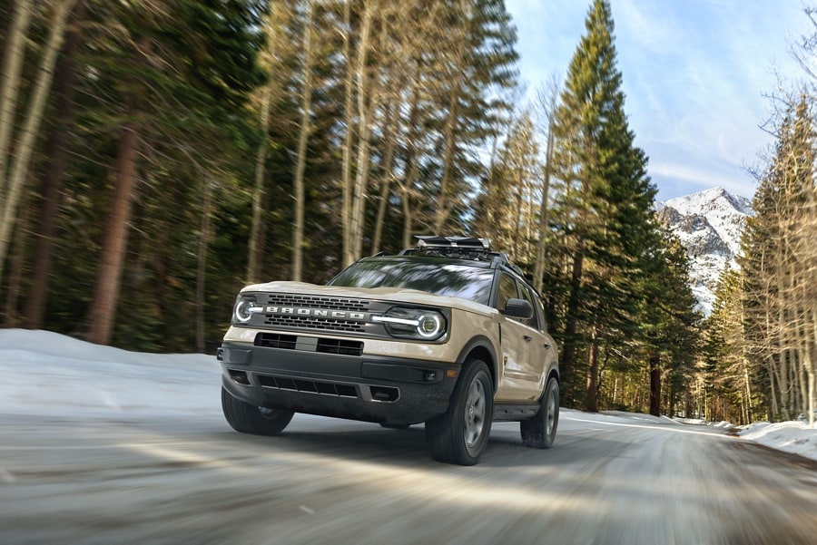 2024 Ford Bronco® Sport SUV being driven down a tree-lined road