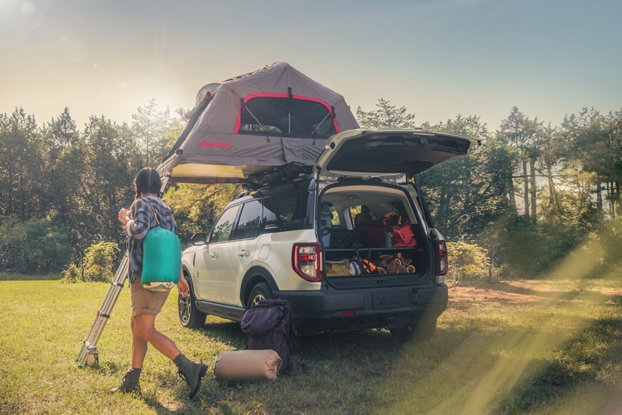 2024 Ford Bronco® Sport shown with a tent on the roof, parked in the grass