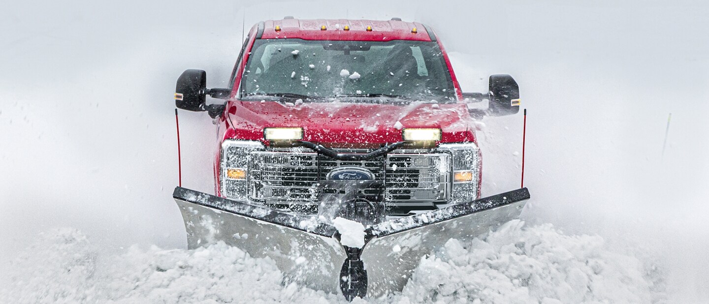 2023 Ford Super Duty® Chassis Cab plowing snow off a snow-covered road