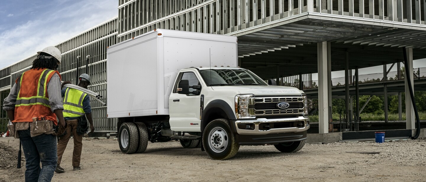 Workers approaching 2023 Ford Super Duty® F-600 in Oxford White with Box Truck Upfit