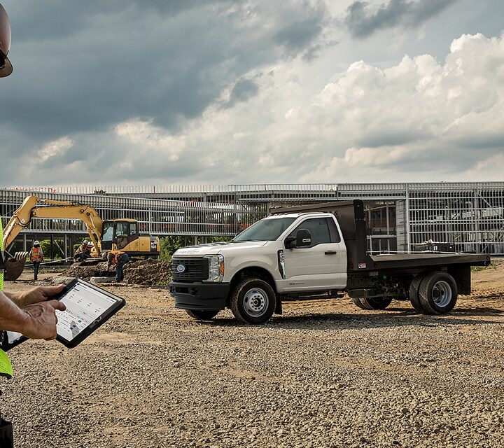 2023 Ford Super Duty® shown on job site with flatbed upfit