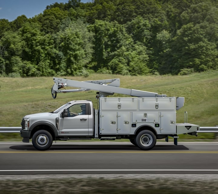 2023 Ford Super Duty® being driven down the highway with bucket upfit