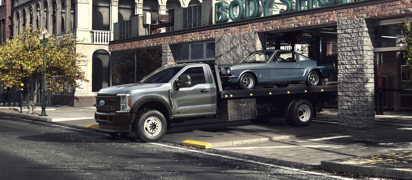 2025 Ford Super Duty® F-600® with tow package hauling a car on the bed