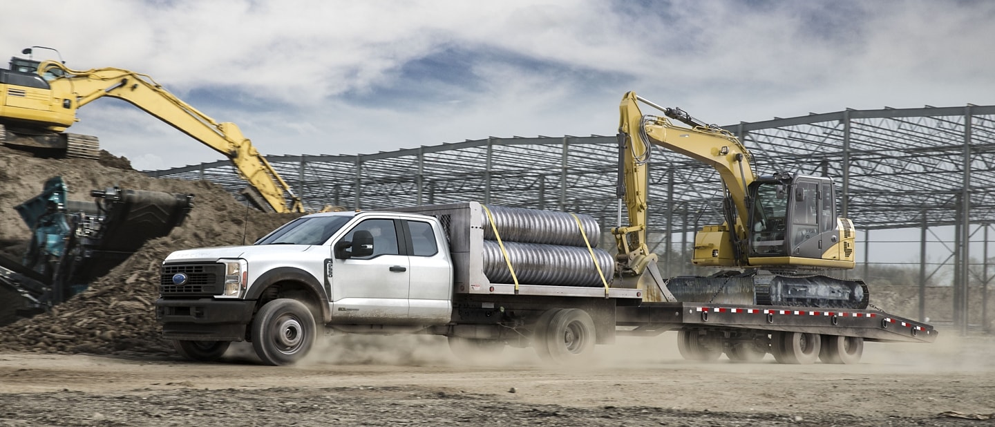 2025 Ford Super Duty® F-350® hauling pipes and doing an excavator