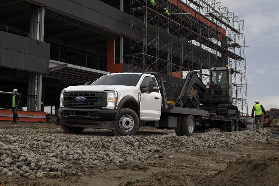 A 2025 Ford Super Duty® F-550® towing an excavator