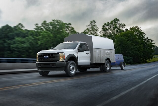 A 2025 Ford Super Duty® with a utility box towing a generator