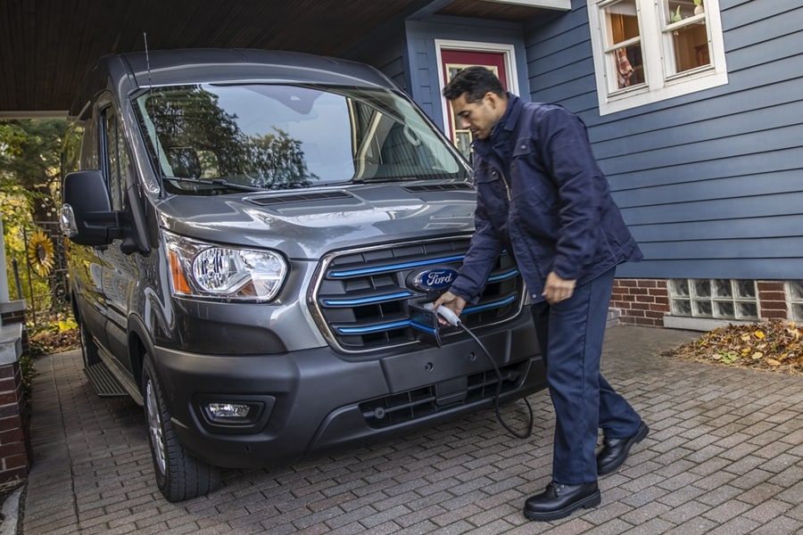 Man shown charging a 2023 Ford E-Transit™ van in his driveway