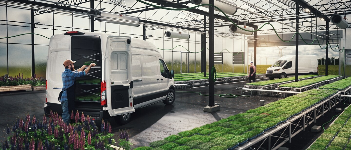 A 2023 Ford E-Transit™ van in a greenhouse being loaded with plants