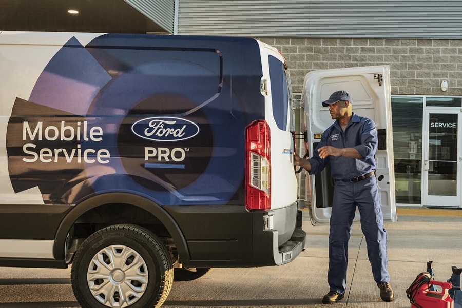 Man stands behind an 2023 Ford E-Transit™ Ford Pro™ truck