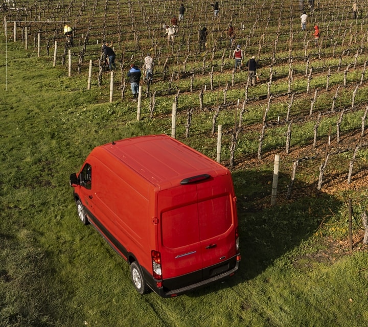 A 2023 Ford E-Transit™ parked at an orchard