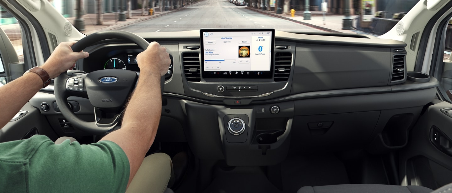 Close-up of a person sitting behind the wheel of the 2023 Ford E-Transit™