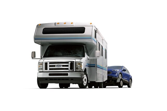 2024 Ford E-Series Cutaway with Class C motorhome towing a car on a trailer