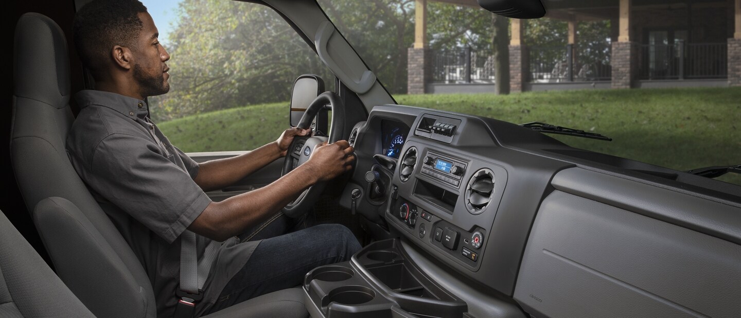 A man in the driver’s seat of a 2024 Ford E-Series Cutaway