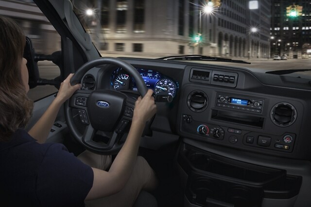 A woman driving a 2024 Ford E-Series Cutaway