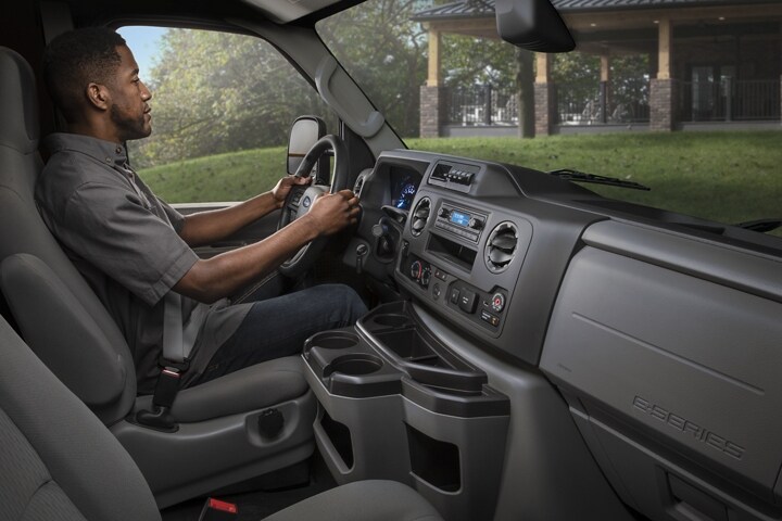 A man in the driver’s seat of a 2025 Ford E-Series Cutaway