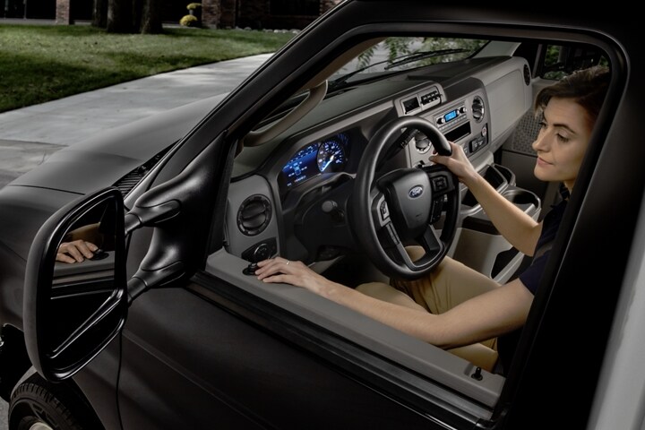 A woman adjusting the available telescoping trailer tow mirrors