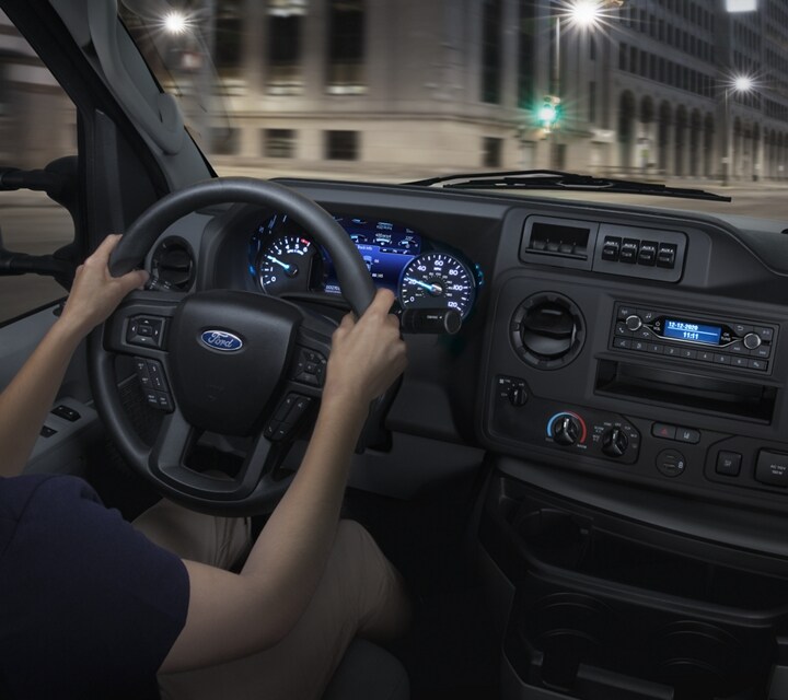 A woman in the driver’s seat of a 2026 Ford E-Series Cutaway